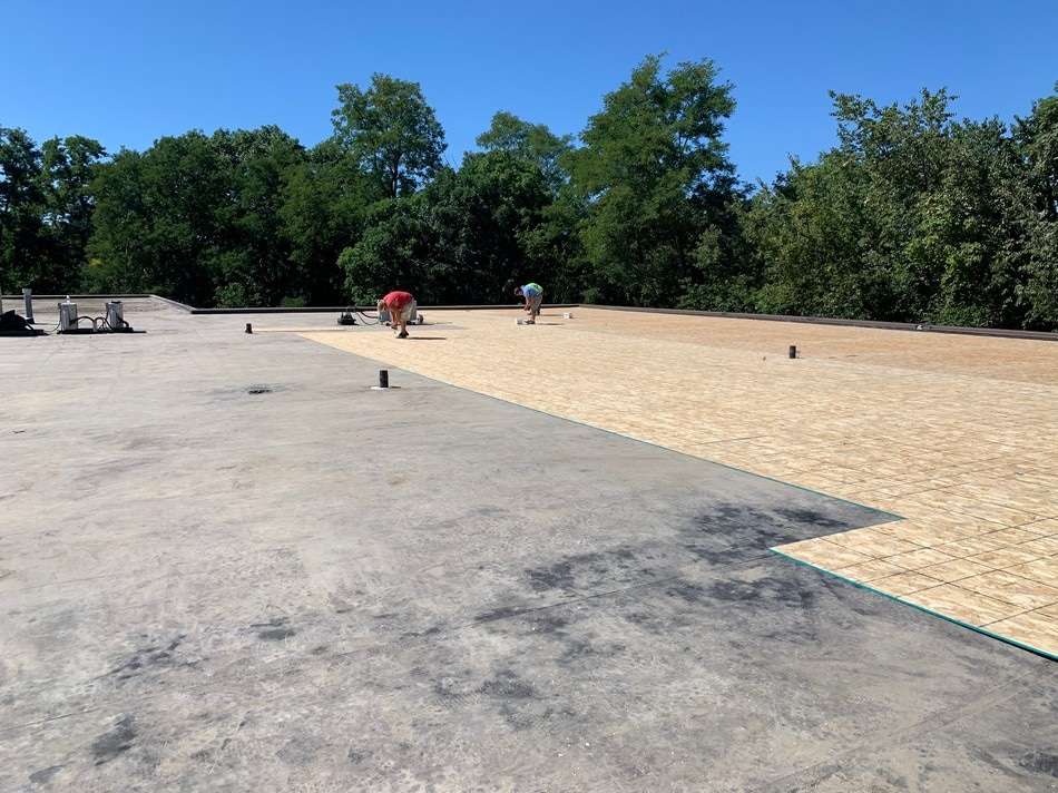 Fabric reinforced membrane system before restoration showing weathered condition requiring professional membrane restoration services